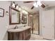 Well-lit bathroom features double vanity with granite countertop, tile floors, and a glass shower with tile surround at 5040 Fawn Valley Dr, Loganville, GA 30052