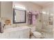 Neutral toned bathroom with glass enclosed shower and marble countertop sink at 5040 Fawn Valley Dr, Loganville, GA 30052