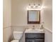 Charming half bathroom features a rustic vanity, modern fixtures, and beadboard paneling at 5040 Fawn Valley Dr, Loganville, GA 30052