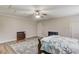 Bedroom with wood-look floors, ceiling fan, and storage, offering a peaceful retreat at 5040 Fawn Valley Dr, Loganville, GA 30052