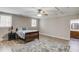 Cozy bedroom featuring wood-look floors, a ceiling fan, and access to an attached bathroom at 5040 Fawn Valley Dr, Loganville, GA 30052