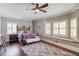 Comfortable bedroom with a ceiling fan, large rug and bay window at 5040 Fawn Valley Dr, Loganville, GA 30052