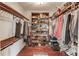 Walk-in closet with wooden storage racks and shelves for clothing and shoes at 5040 Fawn Valley Dr, Loganville, GA 30052