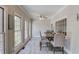 Bright dining area features a ceiling fan, light gray floors and multiple large windows at 5040 Fawn Valley Dr, Loganville, GA 30052