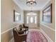 Beautiful foyer with patterned rug, chairs and view of door, creating an inviting space at 5040 Fawn Valley Dr, Loganville, GA 30052