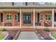 Inviting front porch featuring brick accents and a stylish front door, adding character to the entrance at 5040 Fawn Valley Dr, Loganville, GA 30052