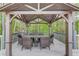 Gazebo with outdoor dining table and seating area offering privacy and shade at 5040 Fawn Valley Dr, Loganville, GA 30052