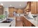 Traditional-style kitchen with wood cabinetry, a double sink, and countertop appliances for everyday cooking at 5040 Fawn Valley Dr, Loganville, GA 30052