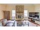 Cozy living room with stone fireplace, hardwood floors, and natural light at 5040 Fawn Valley Dr, Loganville, GA 30052