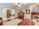 Inviting living room with a fireplace, piano, and an open doorway featuring a unique rustic barn door at 5040 Fawn Valley Dr, Loganville, GA 30052