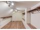 Spacious walk-in closet with wood floors, custom shelving, and natural light provides ample storage at 5040 Fawn Valley Dr, Loganville, GA 30052