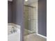A tiled shower featuring a sliding glass door is adjacent to a soaking tub at 3920 High Dove Sw Way # 11, Smyrna, GA 30082