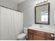 Well lit bathroom with a white shower curtain, vanity, and decorative mirror at 3920 High Dove Sw Way # 11, Smyrna, GA 30082
