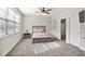Bedroom features a window, ceiling fan, queen bed, and private bathroom at 3920 High Dove Sw Way # 11, Smyrna, GA 30082