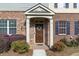Charming brick entryway with decorative wreath and covered porch at 3920 High Dove Sw Way # 11, Smyrna, GA 30082