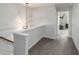 Hallway with a modern light fixture and carpet flooring leads to bedrooms and other living spaces at 3920 High Dove Sw Way # 11, Smyrna, GA 30082