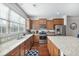 Well-lit kitchen showcases granite countertops, tile backsplash, stainless appliances and wood flooring at 3920 High Dove Sw Way # 11, Smyrna, GA 30082