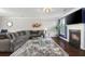 Comfortable living room with fireplace, tv, neutral colored sofa, and dark wood floors at 3920 High Dove Sw Way # 11, Smyrna, GA 30082