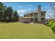 Expansive backyard featuring a lush lawn, mature trees, and a pergola with seating at 4030 Gold Mill Rdg, Canton, GA 30114
