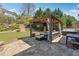 Outdoor patio features a gazebo with comfortable seating, a hot tub, and ample space for entertaining at 4030 Gold Mill Rdg, Canton, GA 30114