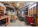 An unfinished basement with exposed ductwork and a work area with various tools and storage at 4030 Gold Mill Rdg, Canton, GA 30114