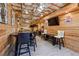 Basement with wood paneling, modern lighting, a bar, and a seating area with a TV at 4030 Gold Mill Rdg, Canton, GA 30114