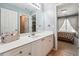 Bright bathroom features a white vanity with a single sink and a view into the main bedroom at 4030 Gold Mill Rdg, Canton, GA 30114