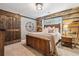Comfortable bedroom featuring a wood accent wall, stylish furnishings, and a sliding barn door at 4030 Gold Mill Rdg, Canton, GA 30114
