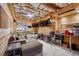 Unique bonus room featuring wood paneled walls, a large sofa, bar area, and multiple televisions at 4030 Gold Mill Rdg, Canton, GA 30114