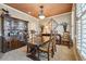 Traditional dining room featuring a large wooden table, decorative hutch, and elegant decor at 4030 Gold Mill Rdg, Canton, GA 30114