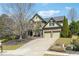 Beautiful home with manicured lawn, mature trees, and a two-car garage at 4030 Gold Mill Rdg, Canton, GA 30114