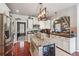 Modern kitchen with stainless steel appliances, granite countertops, kitchen island with wine cooler, and hardwood floors at 4030 Gold Mill Rdg, Canton, GA 30114