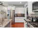 Well-equipped kitchen featuring stainless steel appliances, white cabinets, and granite countertops at 4030 Gold Mill Rdg, Canton, GA 30114