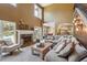 Cozy living room boasting high ceilings, a stone fireplace, large windows, and an opening to the kitchen and dining room at 4030 Gold Mill Rdg, Canton, GA 30114