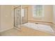 Elegant bathroom featuring a soaking tub and glass-enclosed shower at 4955 Ivy Ridge Se Dr # 404, Atlanta, GA 30339