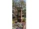 A brick pillar marks the entrance to The Manor, surrounded by lush landscaping and colorful flowers at 4955 Ivy Ridge Se Dr # 404, Atlanta, GA 30339