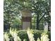 Landscaped community sign for Olde Ivy Vinings Estates with brick base and black iron fence at 4955 Ivy Ridge Se Dr # 404, Atlanta, GA 30339