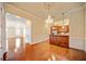 Elegant dining area with hardwood floors, chandelier, and open layout to the kitchen at 4955 Ivy Ridge Se Dr # 404, Atlanta, GA 30339