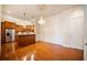 Bright dining space with hardwood floors, chandelier, and kitchen view at 4955 Ivy Ridge Se Dr # 404, Atlanta, GA 30339