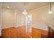 Open dining room with hardwood floors, chandelier, and views of the kitchen at 4955 Ivy Ridge Se Dr # 404, Atlanta, GA 30339