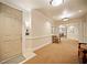 Well-lit hallway featuring neutral carpeting, paneled walls, and stylish sconces at 4955 Ivy Ridge Se Dr # 404, Atlanta, GA 30339