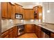 Stylish kitchen with stainless steel appliances, wooden cabinets, and granite countertops at 4955 Ivy Ridge Se Dr # 404, Atlanta, GA 30339
