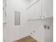 Bright laundry area with tile flooring and white cabinets at 4955 Ivy Ridge Se Dr # 404, Atlanta, GA 30339