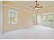 The primary bedroom has white carpet, large windows, and doors to the outside at 4955 Ivy Ridge Se Dr # 404, Atlanta, GA 30339