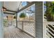 Balcony with decorative white railings and green hanging plants overlooks parking and trees at 708 Mcgill Ne Pl, Atlanta, GA 30312