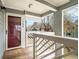 View from covered porch with decorative railings and ferns overlooks a neighborhood landscape at 708 Mcgill Ne Pl, Atlanta, GA 30312
