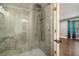 Luxurious bathroom featuring a glass-enclosed shower with modern fixtures and stone-look tile at 708 Mcgill Ne Pl, Atlanta, GA 30312