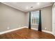 Bedroom with hardwood floors and a large window with elegant curtains at 708 Mcgill Ne Pl, Atlanta, GA 30312