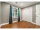 Bedroom with hardwood floors, a window with curtains, and bi-fold closet doors at 708 Mcgill Ne Pl, Atlanta, GA 30312