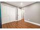 Bedroom featuring hardwood floors, bi-fold closet doors, and doorway to another room at 708 Mcgill Ne Pl, Atlanta, GA 30312